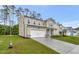 Two-story home with attached two-car garage, lawn, and professional landscaping at 1216 Dimaggio Dr # 29, Raleigh, NC 27616