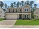 Charming two-story home featuring a two-car garage and well-manicured lawn at 1216 Dimaggio Dr # 29, Raleigh, NC 27616