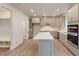 A modern kitchen featuring an island, gray cabinets, stainless steel appliances, and wood-look floors at 1216 Dimaggio Dr # 29, Raleigh, NC 27616