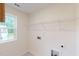 Bright laundry room with window and shelving; utility hookups for washer and dryer at 1216 Dimaggio Dr # 29, Raleigh, NC 27616