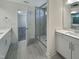 Modern bathroom features double vanity, shower, and tile floors at 1221 Dimaggio Dr # 10, Raleigh, NC 27616