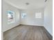 Bedroom with hardwood floors, natural light from two windows at 1221 Dimaggio Dr # 10, Raleigh, NC 27616