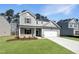 Two-story home featuring a two-car garage, manicured lawn, and neutral siding at 1221 Dimaggio Dr # 10, Raleigh, NC 27616