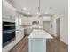 Well-lit kitchen featuring modern appliances, white cabinets, and quartz countertops at 1221 Dimaggio Dr # 10, Raleigh, NC 27616