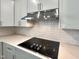 Modern kitchen features stainless hood, white cabinets, subway tile backsplash and quartz counters at 1221 Dimaggio Dr # 10, Raleigh, NC 27616
