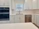 Modern kitchen featuring white cabinets, stainless steel appliances, and a built-in oven at 1221 Dimaggio Dr # 10, Raleigh, NC 27616