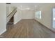 Spacious living room featuring hardwood floors, recessed lighting, and staircase at 1221 Dimaggio Dr # 10, Raleigh, NC 27616
