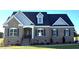 Charming brick home with a blue roof, beautiful dormer, and well-manicured lawn offers great curb appeal at 1665 S Old Carriage Rd, Rocky Mount, NC 27804