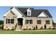 Charming brick home with black shutters, and beautifully landscaped front yard on a sunny day at 1665 S Old Carriage Rd, Rocky Mount, NC 27804