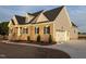 View of the exterior with brick and siding and the three car garage at 1665 S Old Carriage Rd, Rocky Mount, NC 27804