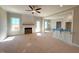 Bright living room with fireplace, modern ceiling fan, and large windows offers a cozy and inviting space at 1665 S Old Carriage Rd, Rocky Mount, NC 27804