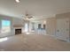 Bright living room with cozy fireplace and modern ceiling fan at 1665 S Old Carriage Rd, Rocky Mount, NC 27804