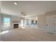 Bright living room features fireplace, ceiling fan, and an opening to the kitchen at 1665 S Old Carriage Rd, Rocky Mount, NC 27804