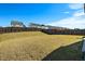 Sloped backyard with a wood fence and view of neighboring houses at 2117 Attend Xing, Fuquay Varina, NC 27526
