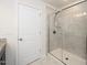 Shower with glass enclosure and gray subway tile in neutral bathroom at 2117 Attend Xing, Fuquay Varina, NC 27526