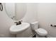 Powder room featuring pedestal sink, bronze fixtures, and elongated toilet at 2117 Attend Xing, Fuquay Varina, NC 27526