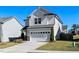 Inviting two-story home featuring a two-car garage and a well-manicured lawn at 2117 Attend Xing, Fuquay Varina, NC 27526