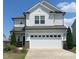 Charming two-story home featuring a two-car garage, light gray siding, and well-maintained landscaping at 2117 Attend Xing, Fuquay Varina, NC 27526