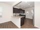 Modern kitchen with stainless steel appliances, granite countertops, stylish cabinets and vinyl wood plank flooring at 2117 Attend Xing, Fuquay Varina, NC 27526
