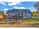 Backyard with screened porch, stairs, and hot tub on a well maintained lawn at 3217 Satterwhite Point Rd, Henderson, NC 27537