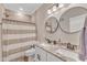 Bathroom with double vanity, granite countertop, round mirrors and shower with curtain at 3217 Satterwhite Point Rd, Henderson, NC 27537