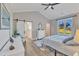 Bedroom featuring a barn door leading to the bathroom and a large window at 3217 Satterwhite Point Rd, Henderson, NC 27537