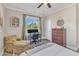 Comfortable bedroom featuring chair, desk, and dresser, with large windows at 3217 Satterwhite Point Rd, Henderson, NC 27537