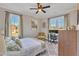 Well-lit bedroom featuring two windows, ceiling fan, and neutral decor at 3217 Satterwhite Point Rd, Henderson, NC 27537