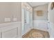 Inviting foyer with decorative wainscoting and stylish flooring, leading to a bright and welcoming home interior at 3217 Satterwhite Point Rd, Henderson, NC 27537