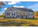 Charming single-story home featuring a welcoming front porch and meticulously landscaped front yard at 3217 Satterwhite Point Rd, Henderson, NC 27537