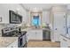 Well-equipped kitchen featuring granite countertops, stainless steel appliances, and custom cabinets for storage at 3217 Satterwhite Point Rd, Henderson, NC 27537