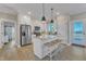 Modern kitchen with granite counters, stainless steel appliances, and an island with seating, perfect for cooking at 3217 Satterwhite Point Rd, Henderson, NC 27537