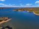 Aerial view of a serene lake with lush greenery at 3217 Satterwhite Point Rd, Henderson, NC 27537