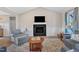 Comfortable living room with fireplace, TV and plush seating, ideal for relaxation and entertainment at 3217 Satterwhite Point Rd, Henderson, NC 27537