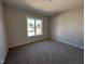 Cozy bedroom with plush carpet, offering natural light through a window at 102 Roma Gora Ct, Princeton, NC 27569