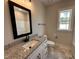 Modern bathroom featuring granite countertops, black fixtures, and hexagon tile flooring at 103 Roma Gora Ct, Princeton, NC 27569