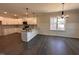 Modern kitchen featuring white cabinets, stainless steel appliances, and an island for extra prep space at 103 Roma Gora Ct, Princeton, NC 27569