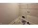 A bare laundry room with fresh gray paint and hexagon tile flooring at 103 Roma Gora Ct, Princeton, NC 27569