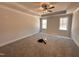 Bright main bedroom with tray ceilings, carpet, and large windows overlooking the yard at 103 Roma Gora Ct, Princeton, NC 27569