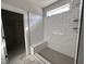 Bathroom features subway tile shower with bench, hexagon tile floor, and window for natural light at 103 Roma Gora Ct, Princeton, NC 27569