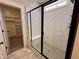 Modern walk-in shower with subway tile, a black frame glass door, and built-in seating at 103 Roma Gora Ct, Princeton, NC 27569