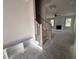 Unfinished staircase and bench in foyer leading to a spacious living room with fireplace and plenty of natural light at 103 Roma Gora Ct, Princeton, NC 27569