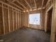 Framed interior space with plywood walls and a window, showing the rough structure of the room at 104 Roma Gora Ct, Princeton, NC 27569