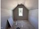 Unfinished attic bedroom featuring drywall, bright window, and rough flooring at 106 Roma Gora Ct, Princeton, NC 27569