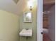Cozy bathroom featuring a corner sink, mirror, and neutral paint at 178 Paceville Rd, Selma, NC 27576