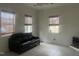 Bright living room with tile floors, a black leather sofa, and natural light at 178 Paceville Rd, Selma, NC 27576