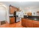 Kitchen featuring wood cabinets, black countertops, and stainless steel refrigerator at 3403 Cardinal Lake Dr, Durham, NC 27704