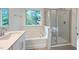 Spa-like bathroom with soaking tub, walk-in shower, and quartz countertop at 7130 Hubner Pl # 34, Cary, NC 27519