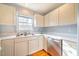 Kitchen features light-colored cabinetry, stainless steel appliances, and double sink at 104 Duncan Ct # B, Chapel Hill, NC 27514