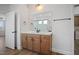 Bathroom with wood vanity, large mirror, and bright lighting at 1221 Cricket St, Elon, NC 27244